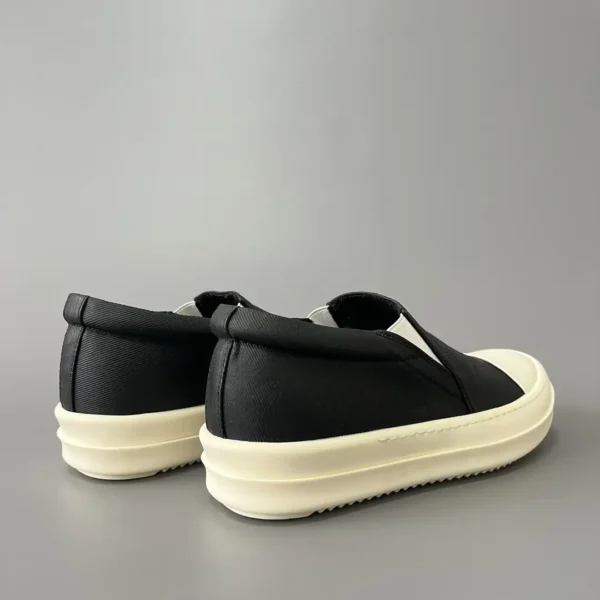 Rick Owens DRKSHDW old wax cloth kicks and covers his feet. - Image 4