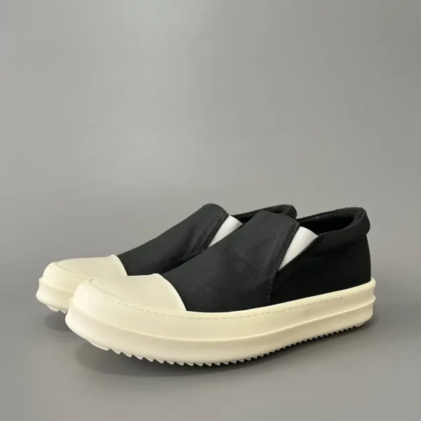 Rick Owens DRKSHDW old wax cloth kicks and covers his feet.