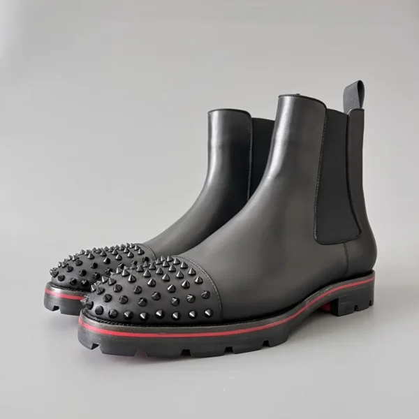 Christian Louboutin Chelsea boots with black cowhide studs.
